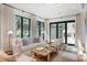 Inviting living room with plush seating, natural light, and serene backyard views at 1 Habersham Nw Way, Atlanta, GA 30305
