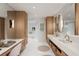 Bright main bathroom with double vanities, marble countertops, built-in storage, and modern lighting at 1 Habersham Nw Way, Atlanta, GA 30305