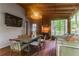 Covered porch featuring wood floors, brick wall with TV, grill and outdoor seating at 1 Habersham Nw Way, Atlanta, GA 30305