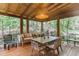 Covered porch featuring wood floors, outdoor furniture and serene view of nature at 1 Habersham Nw Way, Atlanta, GA 30305