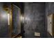Modern powder room with unique textures and a gold-framed mirror at 1 Habersham Nw Way, Atlanta, GA 30305