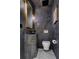 Modern powder room with a unique concrete sink and stylish gold fixtures at 1 Habersham Nw Way, Atlanta, GA 30305