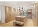 Spacious walk-in closet with custom shelving, storage island and warm wood finishes at 1 Habersham Nw Way, Atlanta, GA 30305