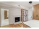 Walk-in closet with a fireplace, marble counters, custom shelving, a display case, and wood floors at 1 Habersham Nw Way, Atlanta, GA 30305