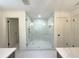 Bathroom featuring glass shower with gold fixtures, marble floors, and white walls at 1892 Mercedes Ne Ct, Atlanta, GA 30345