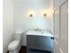 Charming bathroom with gray vanity, marble countertop, and gold fixtures at 1892 Mercedes Ne Ct, Atlanta, GA 30345