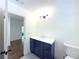 Bathroom with white quartz countertop on navy vanity, modern fixtures, and tile floor at 1892 Mercedes Ne Ct, Atlanta, GA 30345