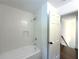 Bathroom with white subway tile surround on bathtub with built in shelf and shower head at 1892 Mercedes Ne Ct, Atlanta, GA 30345
