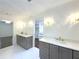 Bathroom featuring marble countertops, gray cabinets, and access to walk-in closet at 1892 Mercedes Ne Ct, Atlanta, GA 30345