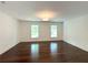 Bright bedroom with hardwood floors, natural light, and views from two windows at 1892 Mercedes Ne Ct, Atlanta, GA 30345