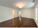 Bedroom with hardwood floors featuring a neutral paint color, natural lighting, and adjacent bathroom at 1892 Mercedes Ne Ct, Atlanta, GA 30345