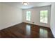 Bedroom with hardwood floors and natural light coming in through two windows at 1892 Mercedes Ne Ct, Atlanta, GA 30345