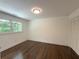 Bedroom with hardwood floors, natural light, and closet with bifold doors at 1892 Mercedes Ne Ct, Atlanta, GA 30345