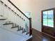 Entryway with a staircase featuring dark wood treads and white risers, and a wood front door at 1892 Mercedes Ne Ct, Atlanta, GA 30345