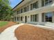 Charming two-story home with a painted brick exterior, a balcony, and a inviting walkway at 1892 Mercedes Ne Ct, Atlanta, GA 30345