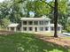 Stunning two-story home with a painted brick exterior, a balcony, and a beautifully landscaped front yard at 1892 Mercedes Ne Ct, Atlanta, GA 30345