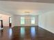Open living room with a contemporary chandelier, hardwood floors, and great natural light at 1892 Mercedes Ne Ct, Atlanta, GA 30345