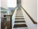 Stairway with hardwood steps and handrail with white risers and walls at 1892 Mercedes Ne Ct, Atlanta, GA 30345