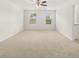 Large, carpeted bedroom with a ceiling fan, offering a comfortable and inviting space at 25 Amberjack Trl, Covington, GA 30016