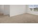 Bedroom features a large window, neutral walls, and carpet at 25 Amberjack Trl, Covington, GA 30016