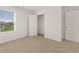 Bright bedroom with large window, neutral carpet, and ensuite bathroom access at 25 Amberjack Trl, Covington, GA 30016