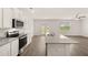 Bright kitchen with stainless appliances, granite countertops and access to the back patio at 25 Amberjack Trl, Covington, GA 30016