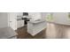 Modern kitchen with a central island, stainless steel appliances, and stylish wood flooring at 25 Amberjack Trl, Covington, GA 30016