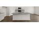 Bright kitchen featuring a center island, stainless appliances and white cabinetry at 25 Amberjack Trl, Covington, GA 30016
