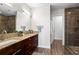 Bathroom with dual sinks and a glass walk-in shower at 905 Juniper Ne St # 808, Atlanta, GA 30309