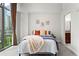 Cozy bedroom with an amazing city view from a large window and curated decor at 905 Juniper Ne St # 808, Atlanta, GA 30309