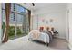 Bedroom featuring a city view, floor-to-ceiling windows with curtains, and a comfortable bed at 905 Juniper Ne St # 808, Atlanta, GA 30309