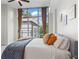 This bedroom offers an amazing city view from a large window, curtains, and decorative pillows at 905 Juniper Ne St # 808, Atlanta, GA 30309