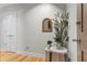 Bright entryway featuring hardwood floors, white trim, a stylish mirror and a decorative plant on a table at 905 Juniper Ne St # 808, Atlanta, GA 30309