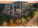 Beautiful mid-rise apartment building with glass windows and balconies, surrounded by mature trees at sunset at 905 Juniper Ne St # 808, Atlanta, GA 30309