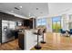 Open-concept kitchen featuring stainless steel appliances, counter seating, and expansive windows at 905 Juniper Ne St # 808, Atlanta, GA 30309