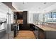 Modern kitchen featuring stainless steel appliances, granite countertops, and dark wood cabinetry at 905 Juniper Ne St # 808, Atlanta, GA 30309