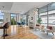 Open living space with floor-to-ceiling windows, hardwood floors, modern lighting, and comfortable seating area at 905 Juniper Ne St # 808, Atlanta, GA 30309
