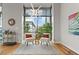 Cozy sitting area features hardwood floors, large window with city view, stylish furnishings, and modern lighting at 905 Juniper Ne St # 808, Atlanta, GA 30309
