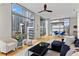 Bright living room with hardwood floors, modern ceiling fan, and floor-to-ceiling windows with views at 905 Juniper Ne St # 808, Atlanta, GA 30309