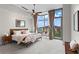 Bright primary bedroom with large windows, modern ceiling fan, and adjacent sitting area at 905 Juniper Ne St # 808, Atlanta, GA 30309
