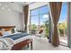 Main bedroom featuring a large window with city view, ceiling fan and seating area at 905 Juniper Ne St # 808, Atlanta, GA 30309