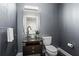 Stylish powder room with a vessel sink, elegant vanity, and modern fixtures in a gray-toned palette at 905 Juniper Ne St # 808, Atlanta, GA 30309