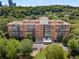 Aerial view of the building with tree coverage around the building and parking at 130 26Th Nw St # 415, Atlanta, GA 30309