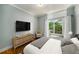 Comfortable bedroom offering access to a private balcony with wooded views at 130 26Th Nw St # 415, Atlanta, GA 30309