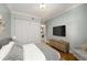 Spacious bedroom with hardwood floors, flat screen TV, and modern decor at 130 26Th Nw St # 415, Atlanta, GA 30309