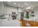Well-lit kitchen with stainless steel appliances, white cabinets, and a quartz countertop at 130 26Th Nw St # 415, Atlanta, GA 30309