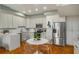 Bright kitchen featuring stainless steel appliances and breakfast nook with clear chairs at 130 26Th Nw St # 415, Atlanta, GA 30309