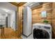 Efficient laundry area with wood paneling, modern washer, and ample storage for convenience at 130 26Th Nw St # 415, Atlanta, GA 30309