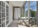 Sun-drenched patio with floor-to-ceiling windows and a cozy dining set at 130 26Th Nw St # 415, Atlanta, GA 30309