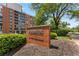 Exterior building sign for Brookwood Park Condominium with lush landscaping at 130 26Th Nw St # 415, Atlanta, GA 30309